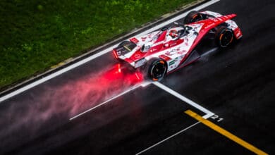 Aerial/rear shot of Norman Nato on-track in the #23 car with spray coming up from the wet track behind